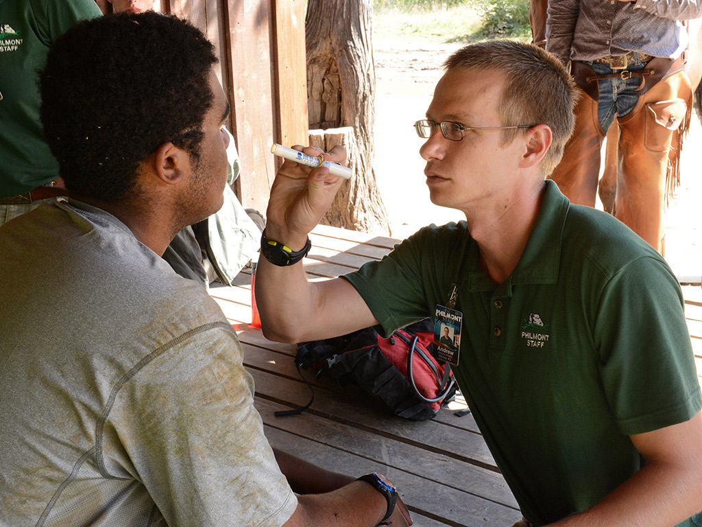 Student checking a man's eye sight
